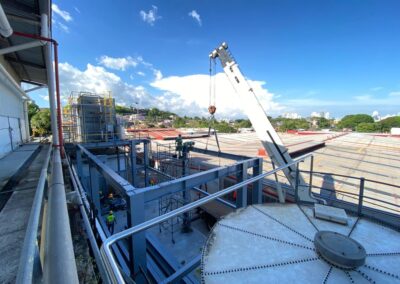Crane lifting materials at industrial site.