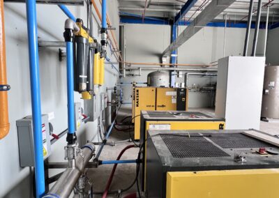 Industrial machines with colorful pipes and cables.