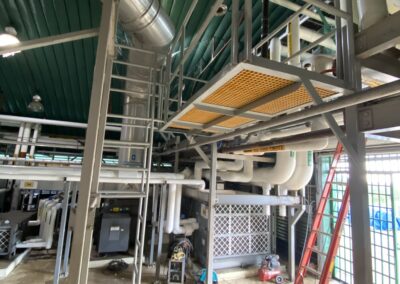 Industrial interior with pipes and metal structures.