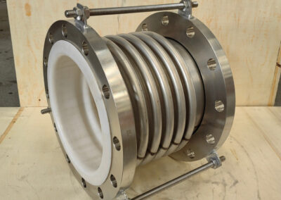 Metal expansion joint with flange and bolts.