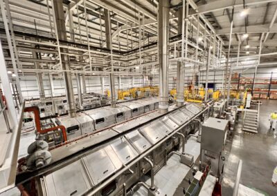Industrial factory interior with machinery and pipes.