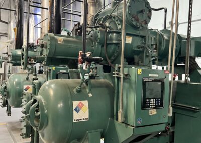 Industrial machinery with pipes and control panel.