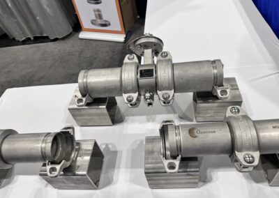 Industrial metal pipe valves on display table.